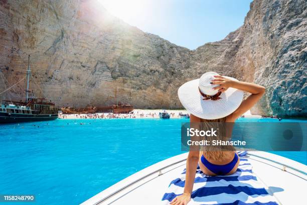 Woman On A Boat Enjoys The View To The Shipwreck Beach Navagio In Zakynthos Greece Stock Photo - Download Image Now