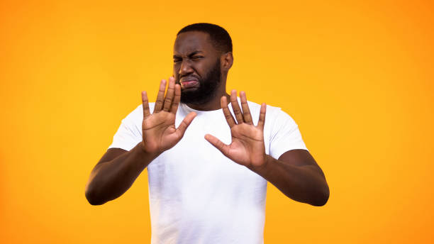Displeased young black guy showing rejection gesture, negative attitude, refuse Displeased young black guy showing rejection gesture, negative attitude, refuse disgust stock pictures, royalty-free photos & images