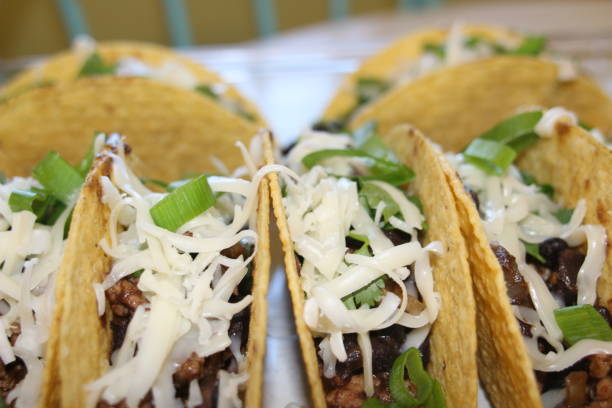 istock three beef tacos with cheese, lettuce and tomatoes 1158248812