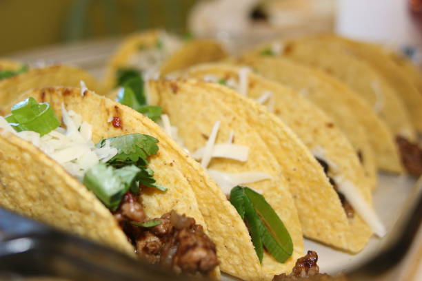 istock three beef tacos with cheese, lettuce and tomatoes 1158248815