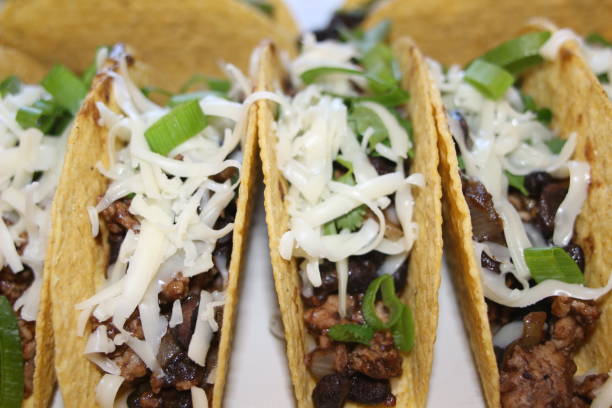 istock three beef tacos with cheese, lettuce and tomatoes 1158248816