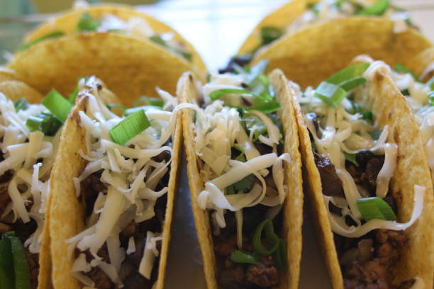 istock three beef tacos with cheese, lettuce and tomatoes 1158248818