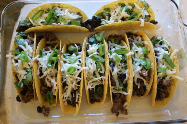 istock three beef tacos with cheese, lettuce and tomatoes 1158248819