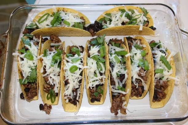 istock three beef tacos with cheese, lettuce and tomatoes 1158248820