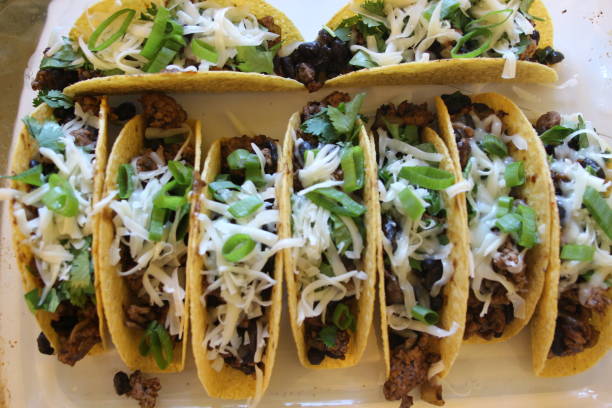 istock three beef tacos with cheese, lettuce and tomatoes 1158248825