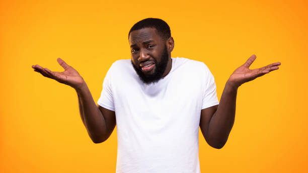 istock Confused afro-american man showing no idea gesture, problem hesitation, choice 1158248867
