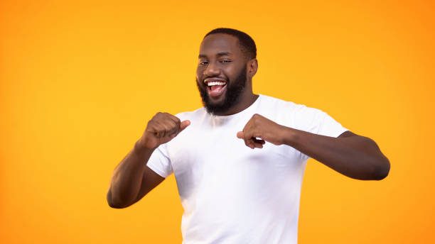 istock Joyful black male dancing on bright background, achievement happiness, fun 1158248868