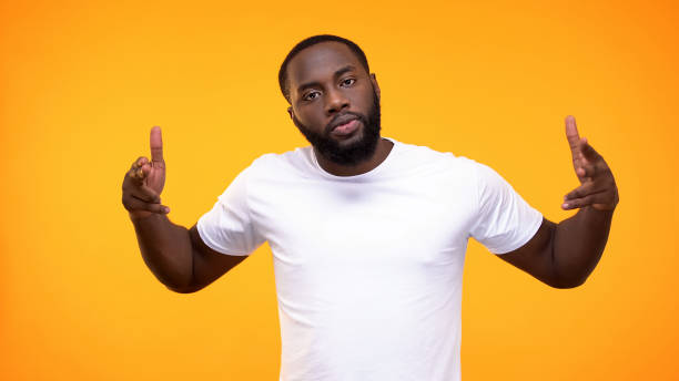 istock Angry black male pointing finger guns on camera on yellow background, aggression 1158248878