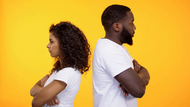 istock Offended multiracial couple ignoring each other standing back, relations crisis 1158248970