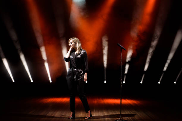 istock Singer on scene in the club. Bright stage lighting. 1158249692