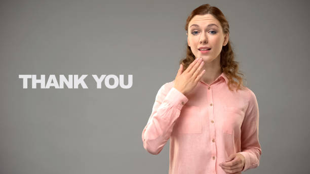 woman saying thank you in sign language, text on background, communication - american sign language imagens e fotografias de stock