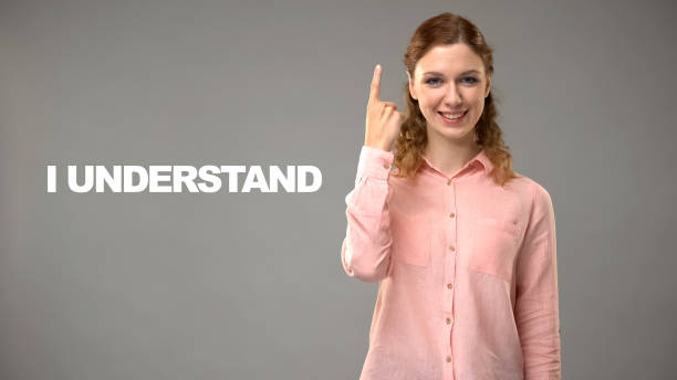 istock Teacher saying i understand in asl, text on background, communication for deaf 1158249859