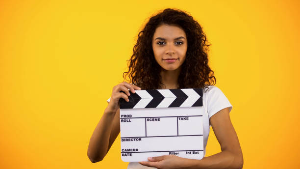 Attractive black woman holding clapper board, film studio, actor audition, clip Attractive black woman holding clapper board, film studio, actor audition, clip audition photos stock pictures, royalty-free photos & images