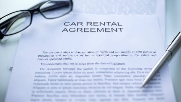 istock Car rental agreement lying on table, pen and eyeglasses on official document 1158250037