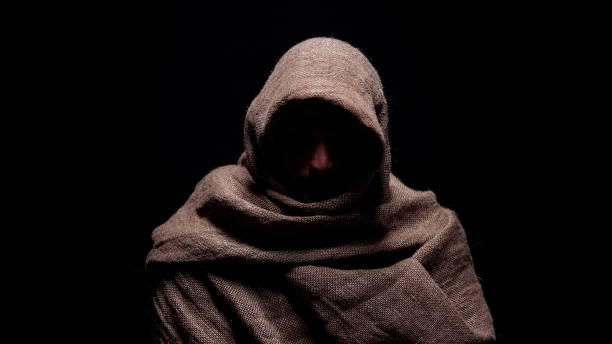 istock Poor man in rough robe looking down with humility, early christian prophet 1158250123