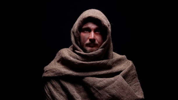 Poor male in rough robe looking directly to camera, early christian prophet