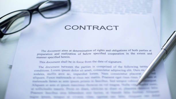 istock Contract lying on table, pen and eyeglasses on official document, business 1158250216