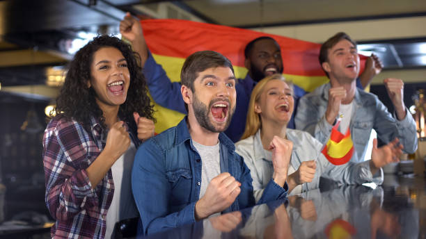 istock Extremely happy Spanish supporters waving national flag, celebrating victory 1158250501