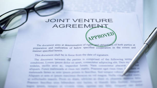 Joint venture agreement approved, seal stamped on official document, business stock photo