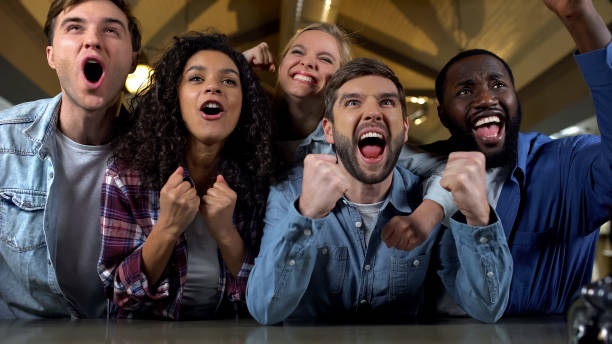 istock Excited young people supporting team, watching match together, rejoicing victory 1158250590