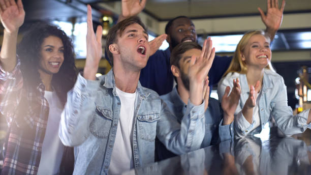 istock Multi-racial friends supporting team watching game together, clapping hands 1158250710