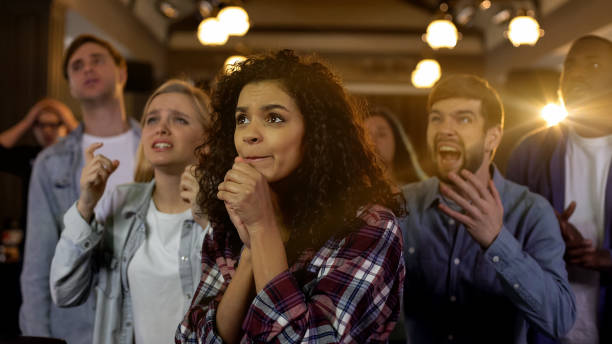 istock Young spectators worrying about favorite team, multi-racial fans at stadium 1158250757