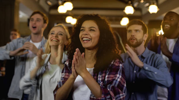 istock Positive sport fans cheering, clapping hands together and shouting exclamations 1158250794