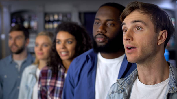 istock Concentrated supporters attentively watching tv, waiting for contest results 1158250832