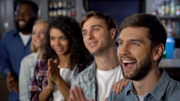 istock Cheerful match spectators celebrating goal, supporting team, entertainment 1158250957