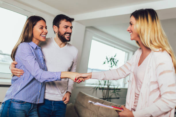 istock Real Estate agent shows interior to young couple 1158253506