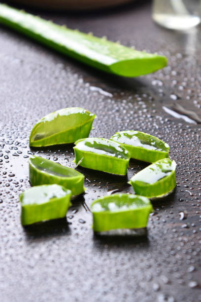 aloe vera slice with water drops on wooden table. stock photo