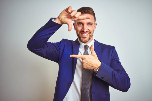 istock Young handsome business man over white isolated background smiling making frame with hands and fingers with happy face. Creativity and photography concept. 1158256429