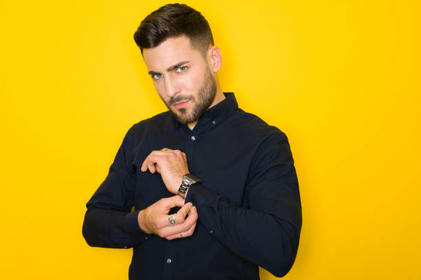istock Young handsome man possing and modeling over yellow isolated background 1158256758