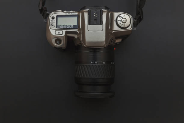 istock Photographer workplace with dslr camera system on dark black table background. Hobby travel photography concept 1158258860
