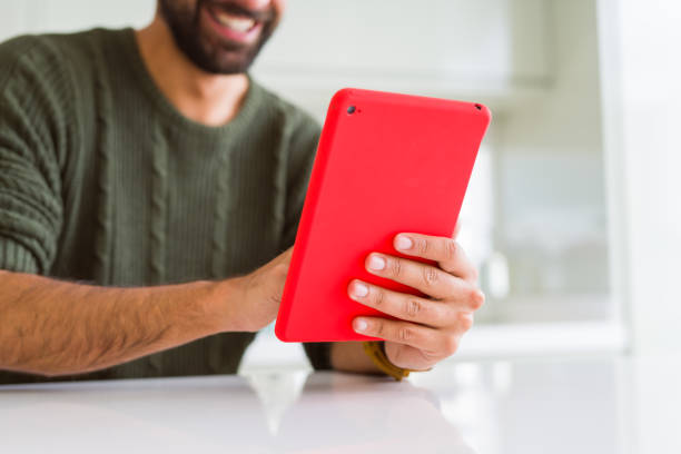 istock Close up of man using touchpad tablet and smiling 1158259732