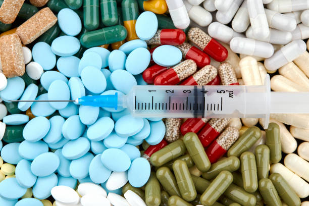 istock Syringe, many colorful pills and capsules. Medicine 1158267949