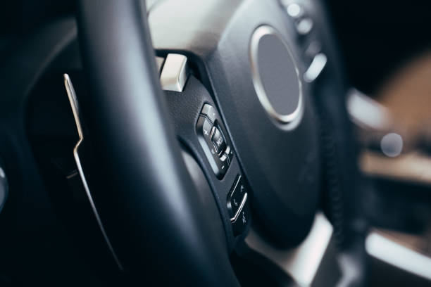 istock close up Modern black steering wheel with multifunction buttons Integrated stereo controls pushes the for quick control technology in the car. 1158268194