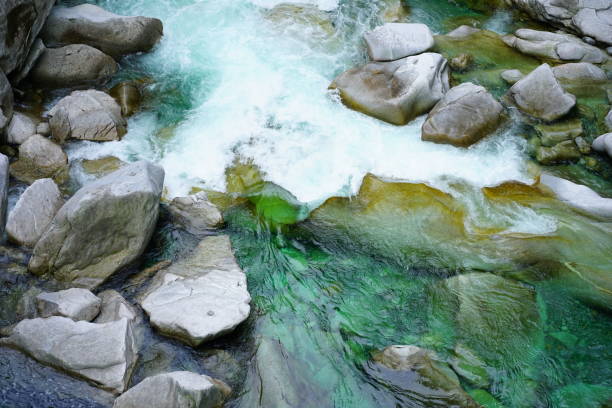 istock Water with green color flows in the rocks 1158271026