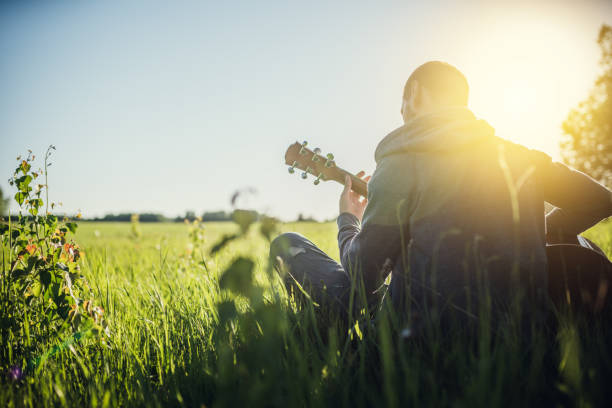 istock Man playing acoustic guitar outdoors 1158271963