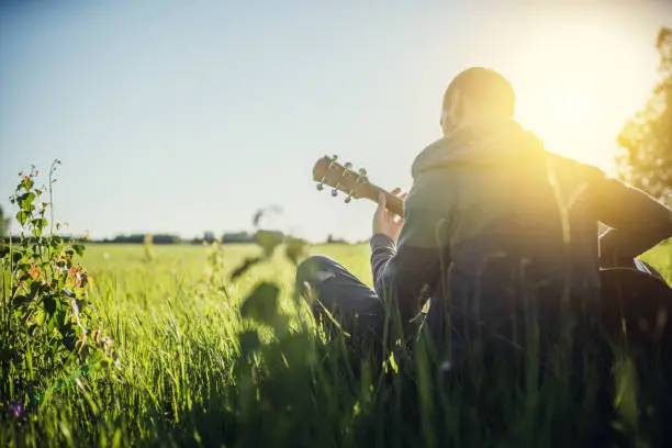 Man playing acoustic guitar outdoors