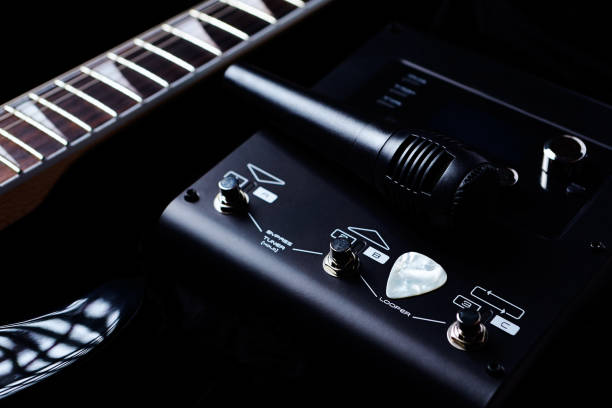 istock Multieffects Processor for Electric Guitar and a Microphone on black background. Close up. 1158273097