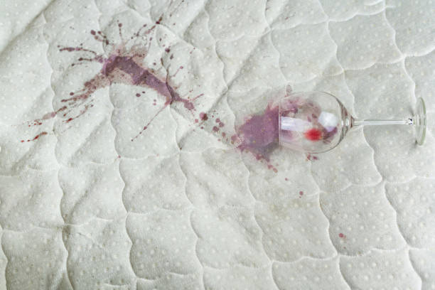 wine glass spilled on bed. dropped wineglass on white bed sheet. pink wet stain. unlucky, unfortunate situation. - wine glass white wine wineglass imagens e fotografias de stock