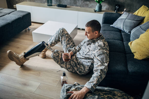 istock Depressed soldier with prosthetic leg drinking to forget 1158273787