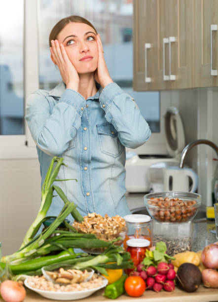 istock Woman suffering from headache at kitchen 1158274600