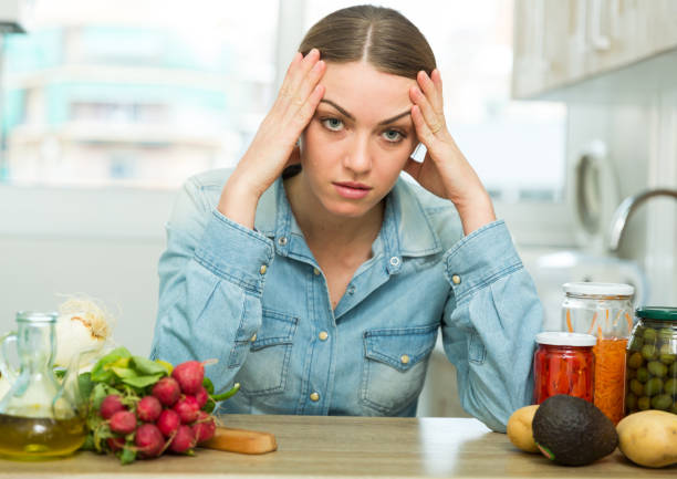 istock Depressed housewife sitting in kitchen 1158274603