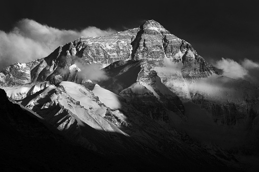 Dramatic light at dusk across the North face of Mount Everest in Himalayas of Tibet 
Mount Everest, known in Nepali as Sagarmatha and in Tibetan as Chomolungma, is Earth's highest mountain above sea level, located in the Mahalangur Himal sub-range of the Himalayas. The international border between Nepal and China runs across its summit point