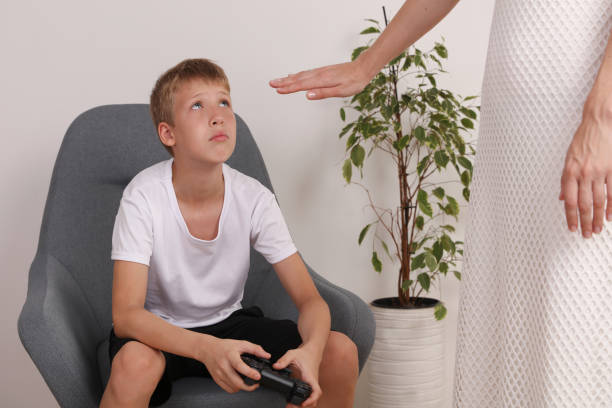 istock Computer games addiction. Mother warning her son to stop playing. Children Punishment 1158276973
