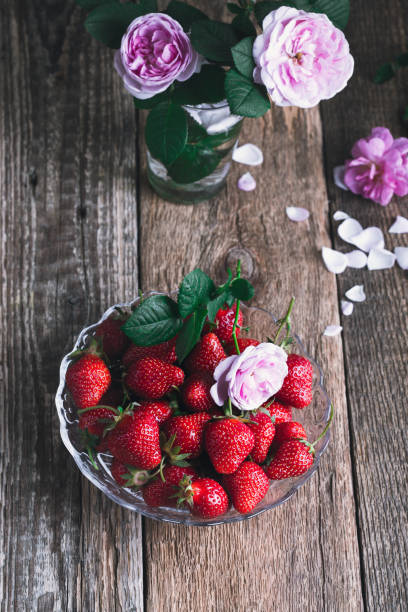 istock Strawberry in glass bowl on rustic wooden table 1158277071