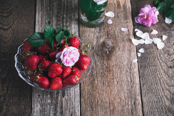 istock Strawberry in glass bowl on rustic wooden table 1158277075