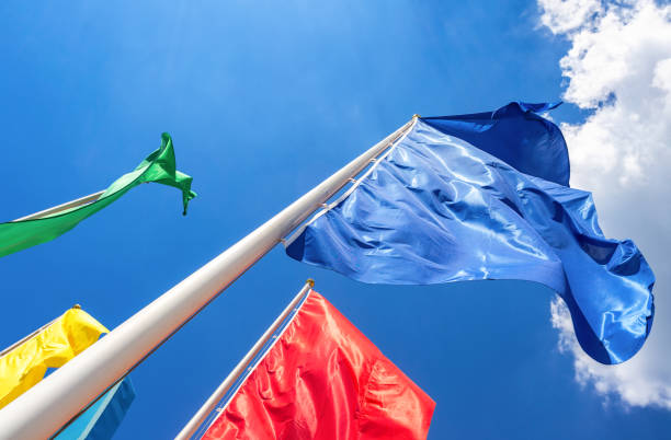 Colorful flags in the wind against the blue sky background